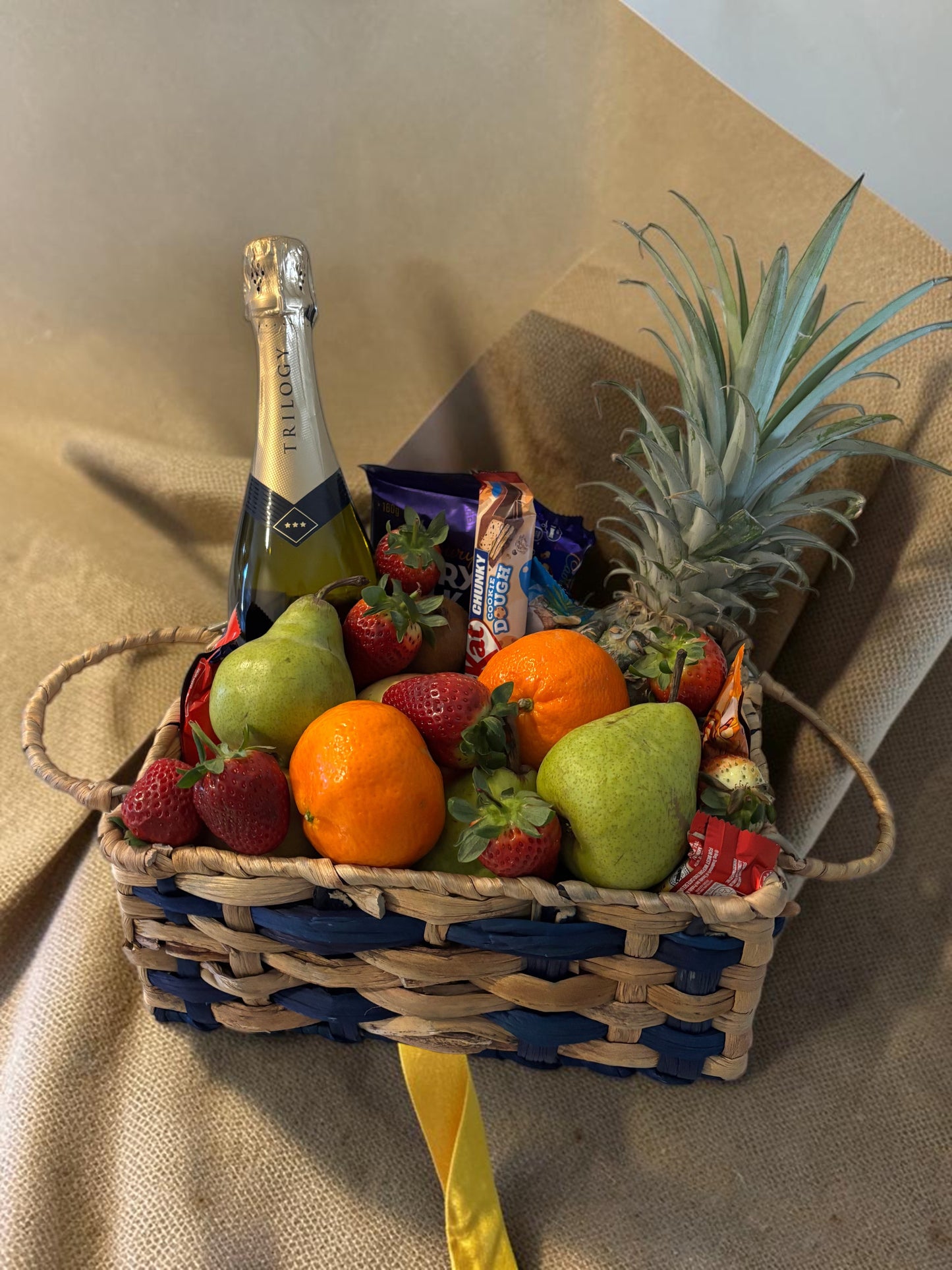 Donut Bouquet Canberra gift hamper featuring sparkling wine, fresh strawberries, pears, oranges, and chocolates.
