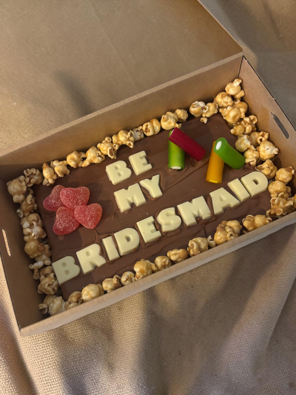 Donut Bouquet Canberra gluten free brownie block with white chocolate message, popcorn, and assorted lollies