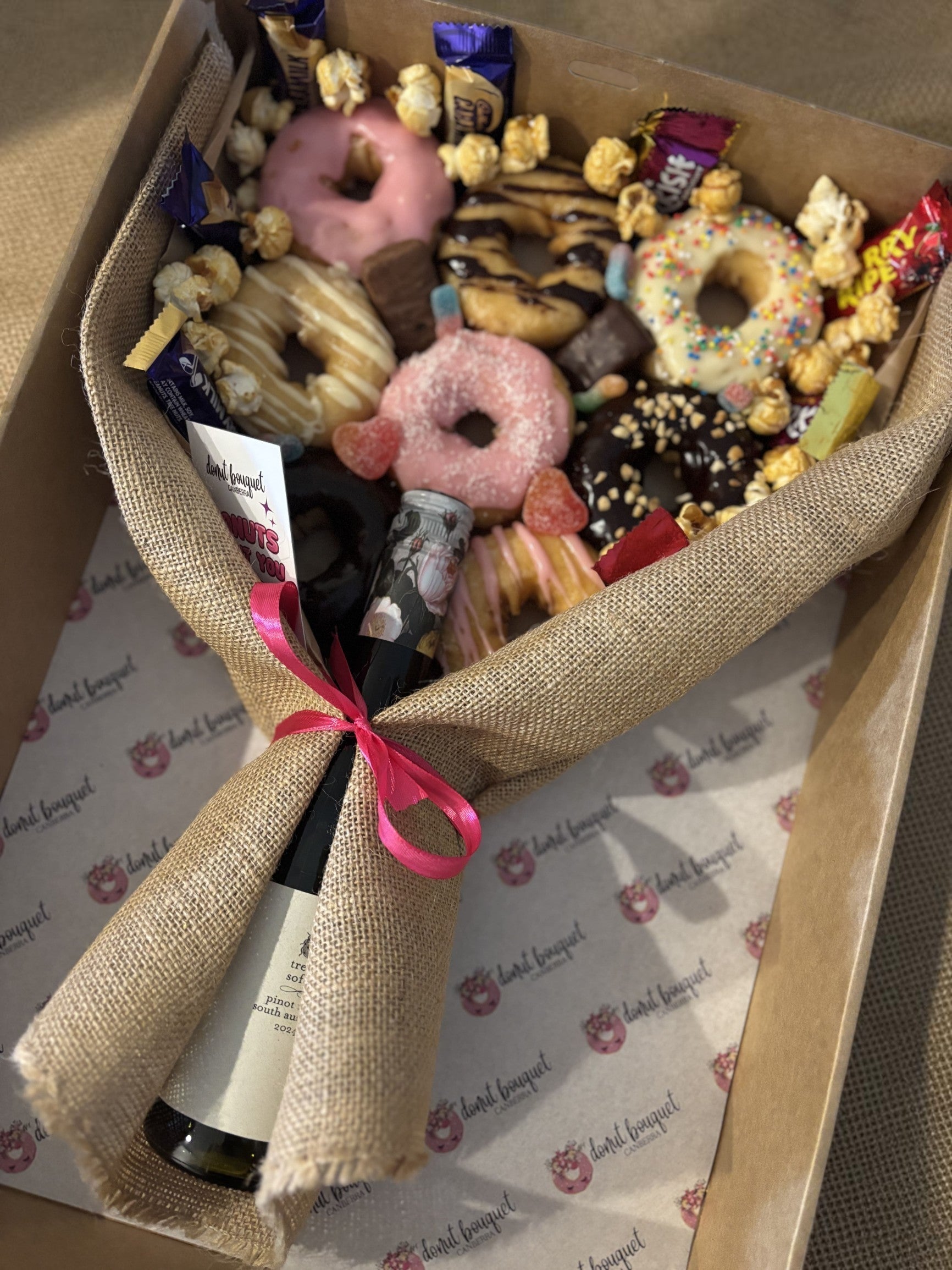Donut Bouquet Canberra gluten free donut bouquet gift hamper with assorted donuts, chocolates, and a bottle of wine.