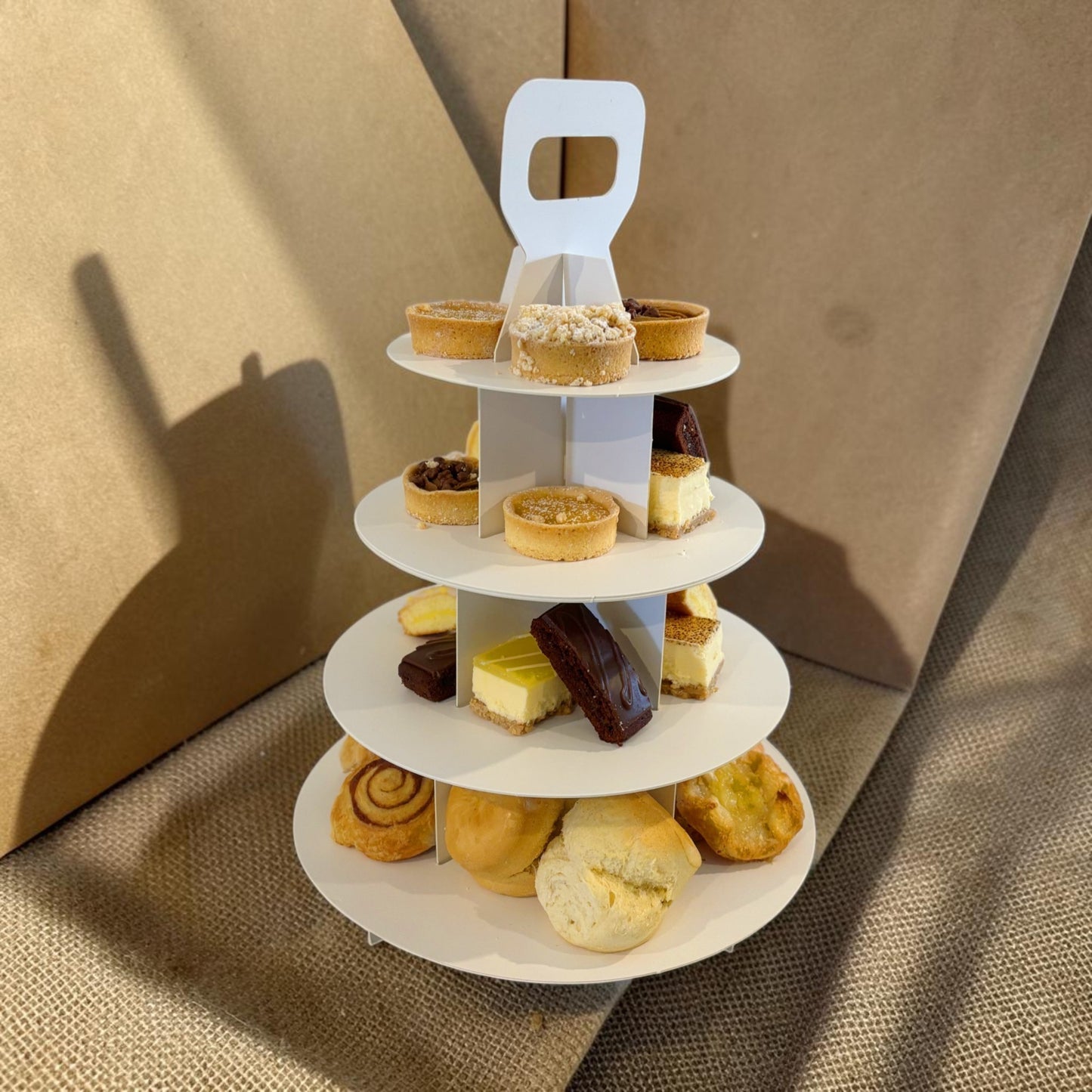 Donut Bouquet Canberra gluten free high tea set featuring an assortment of sweet treats on a three-tier white stand.