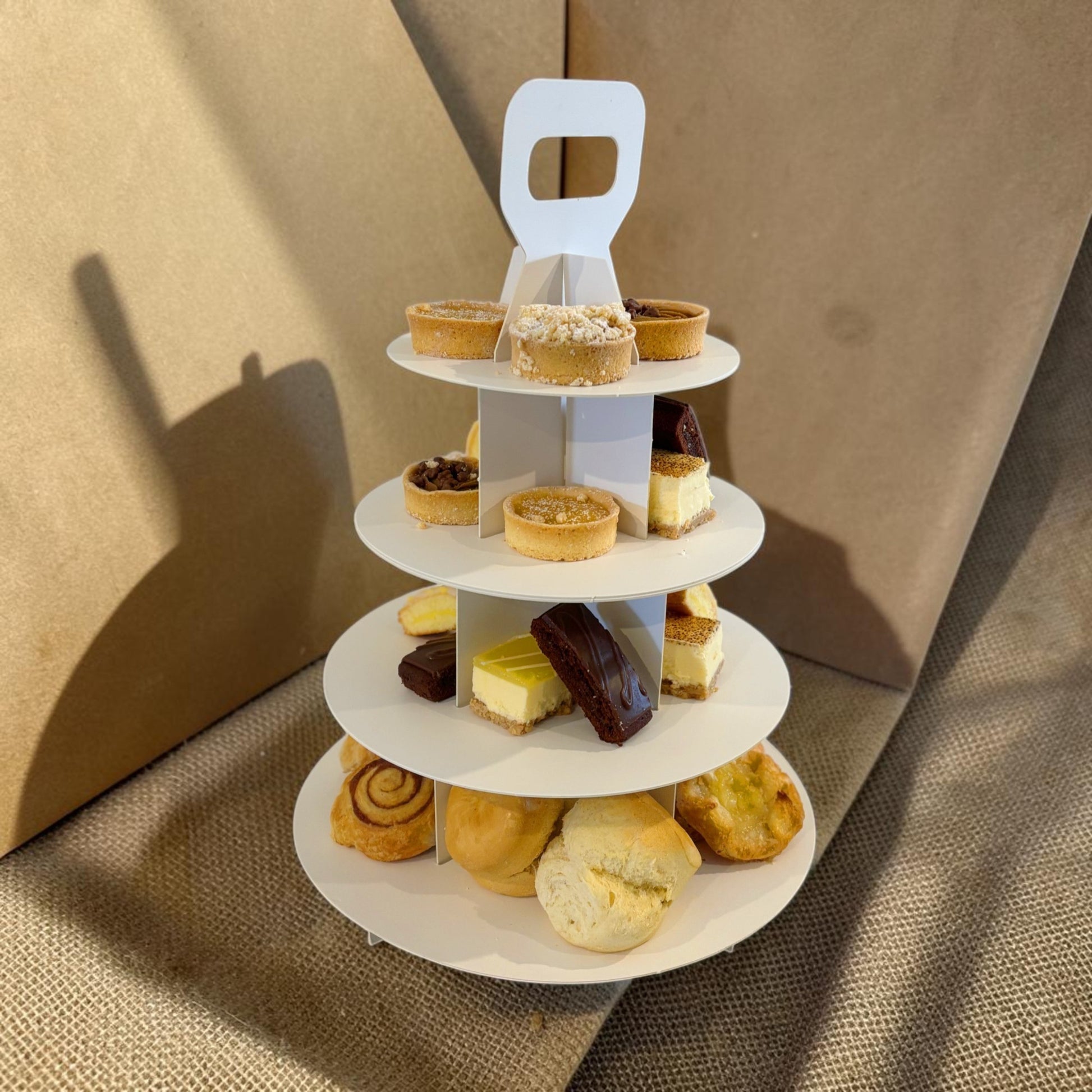 Donut Bouquet Canberra gluten free high tea set featuring an assortment of sweet treats on a three-tier white stand.