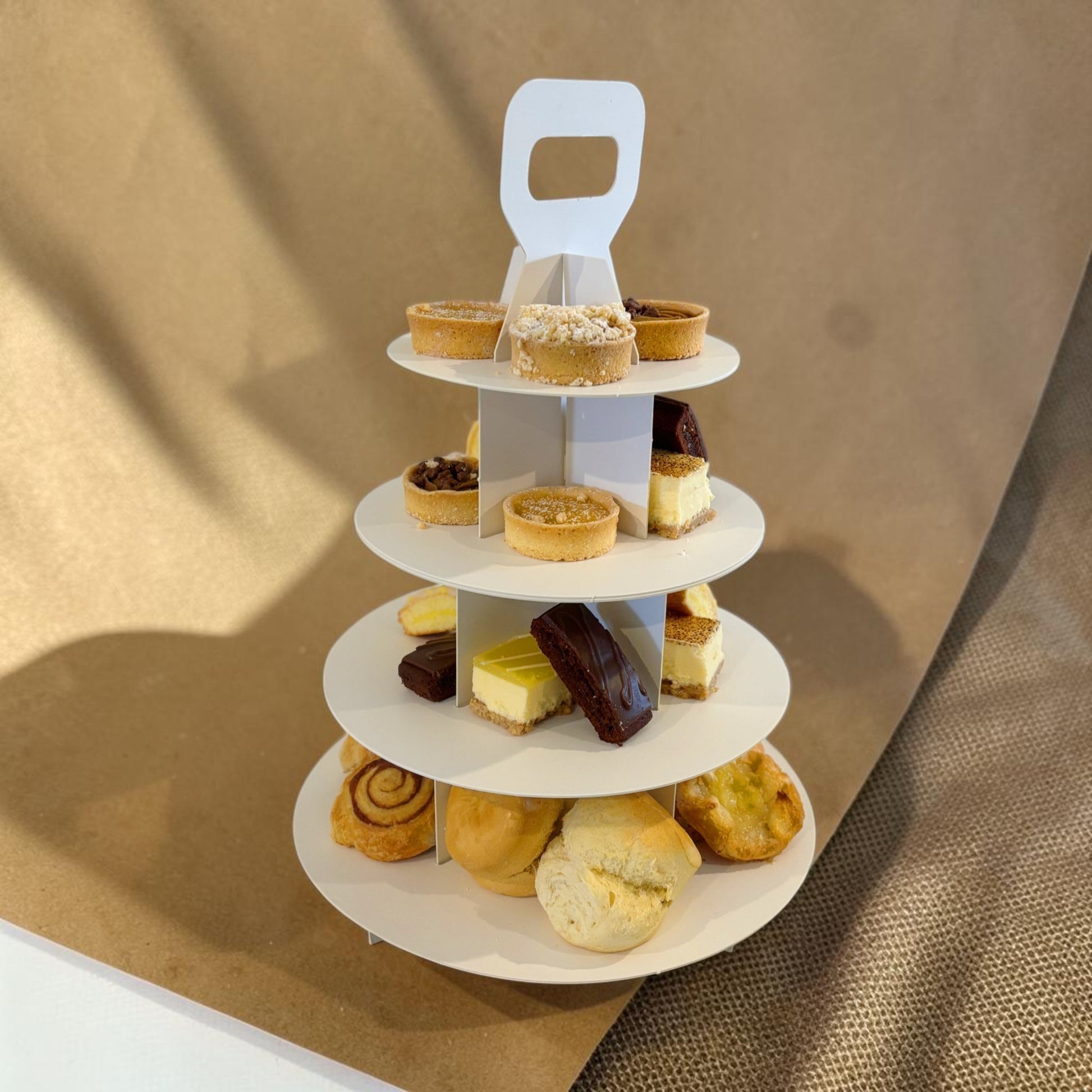 Donut Bouquet Canberra gluten free high tea set with assorted pastries, cakes, and tarts on a three-tier white stand.