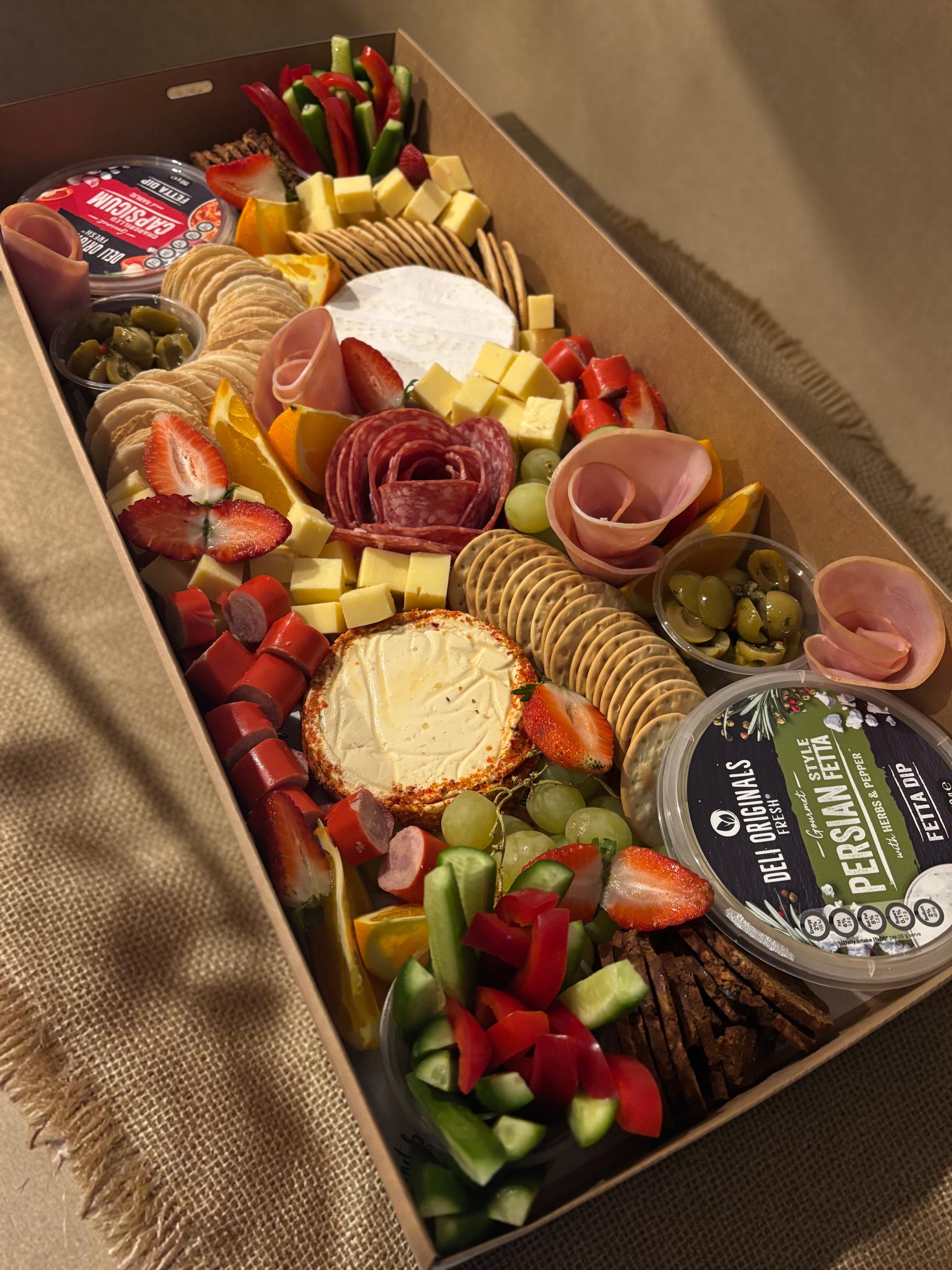 Donut Bouquet Canberra grazing box featuring salami rose, assorted cheeses, crackers, fresh fruit, and veggie sticks.