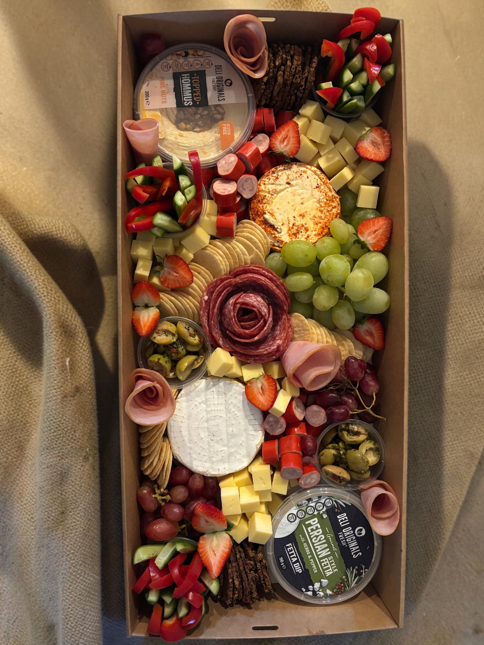 Donut Bouquet Canberra grazing box featuring salami rose, assorted cheeses, crackers, fresh fruit, and veggie sticks.