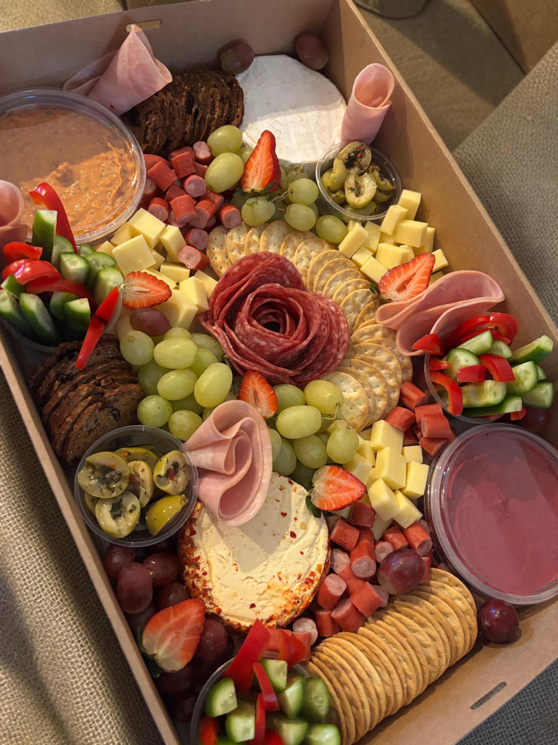 Donut Bouquet Canberra grazing box featuring salami rose, assorted cheeses, crackers, fresh fruit, and veggie sticks.