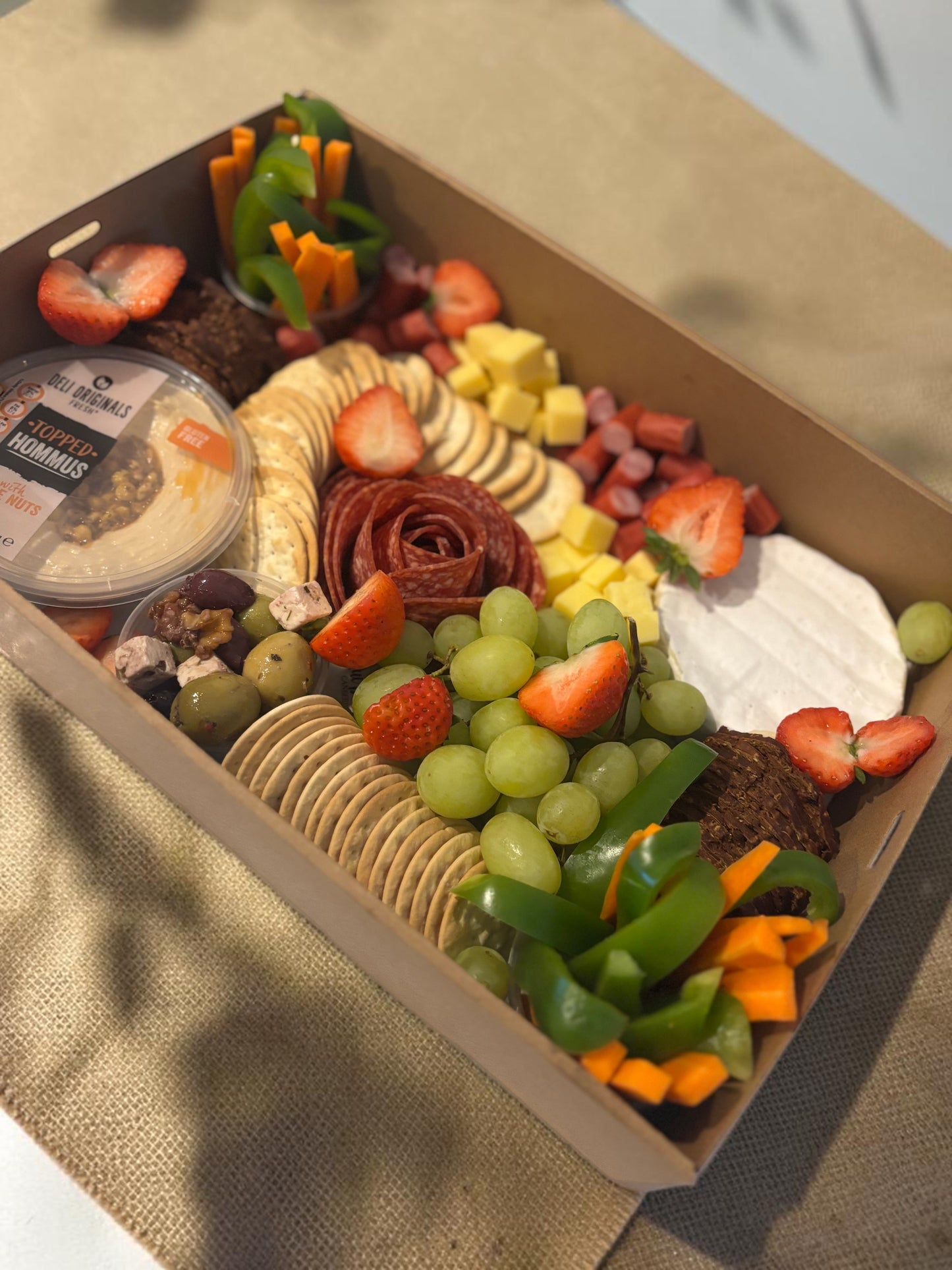 Donut Bouquet Canberra grazing box with cheese, salami rose, crackers, hummus, fresh fruit, and vegetables.
