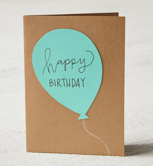 Donut Bouquet Canberra larger greeting card with a teal balloon cutout featuring Happy Birthday text on kraft paper