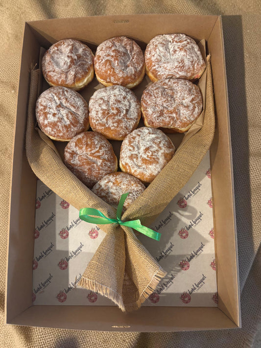 Donut Bouquet Canberra jam donut bouquet featuring nine powdered sugar donuts wrapped in hessian with a ribbon