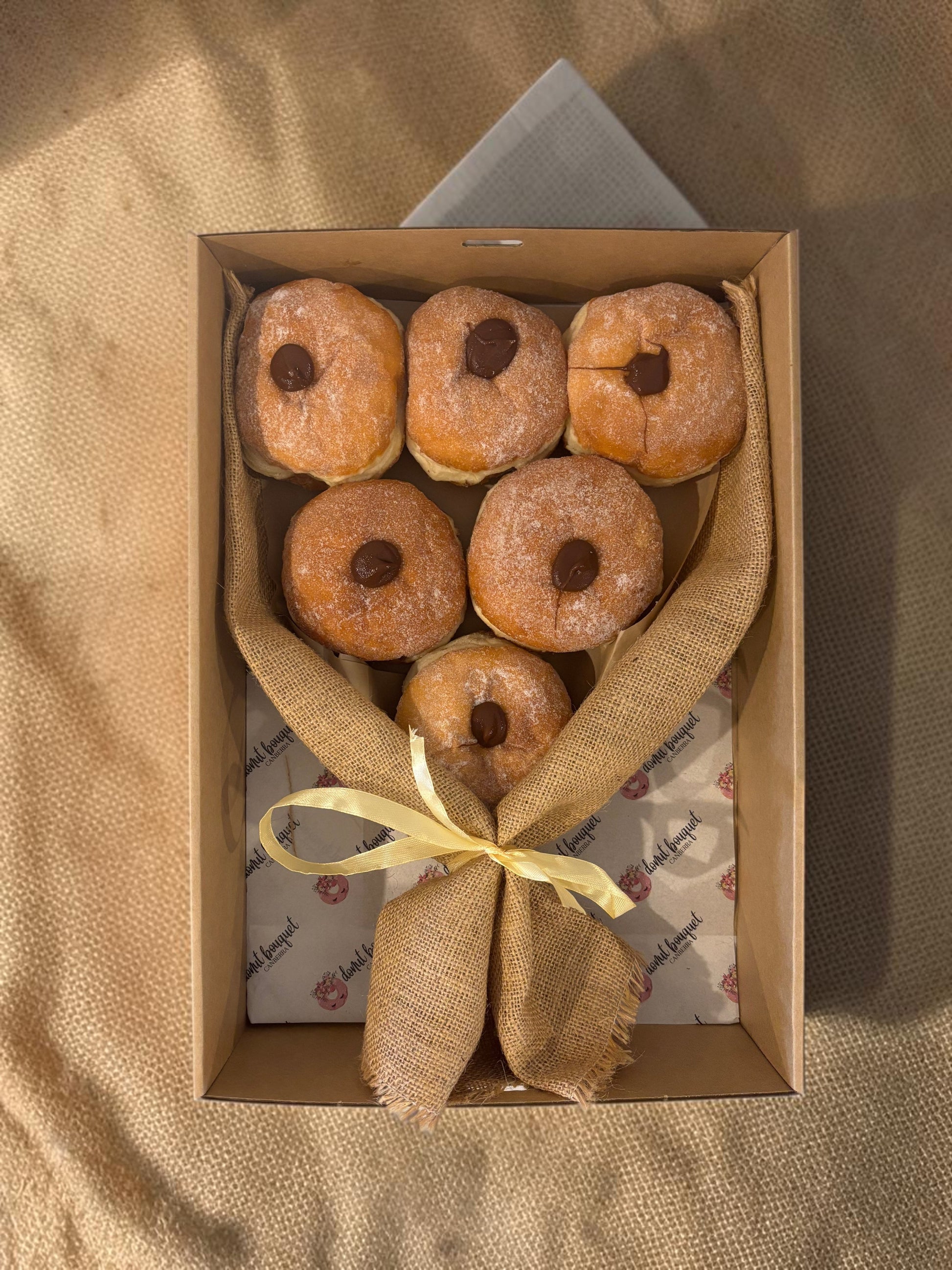 Donut Bouquet Canberra premium 6 pack Nutella donut bouquet wrapped in rustic hessian with a ribbon in a box