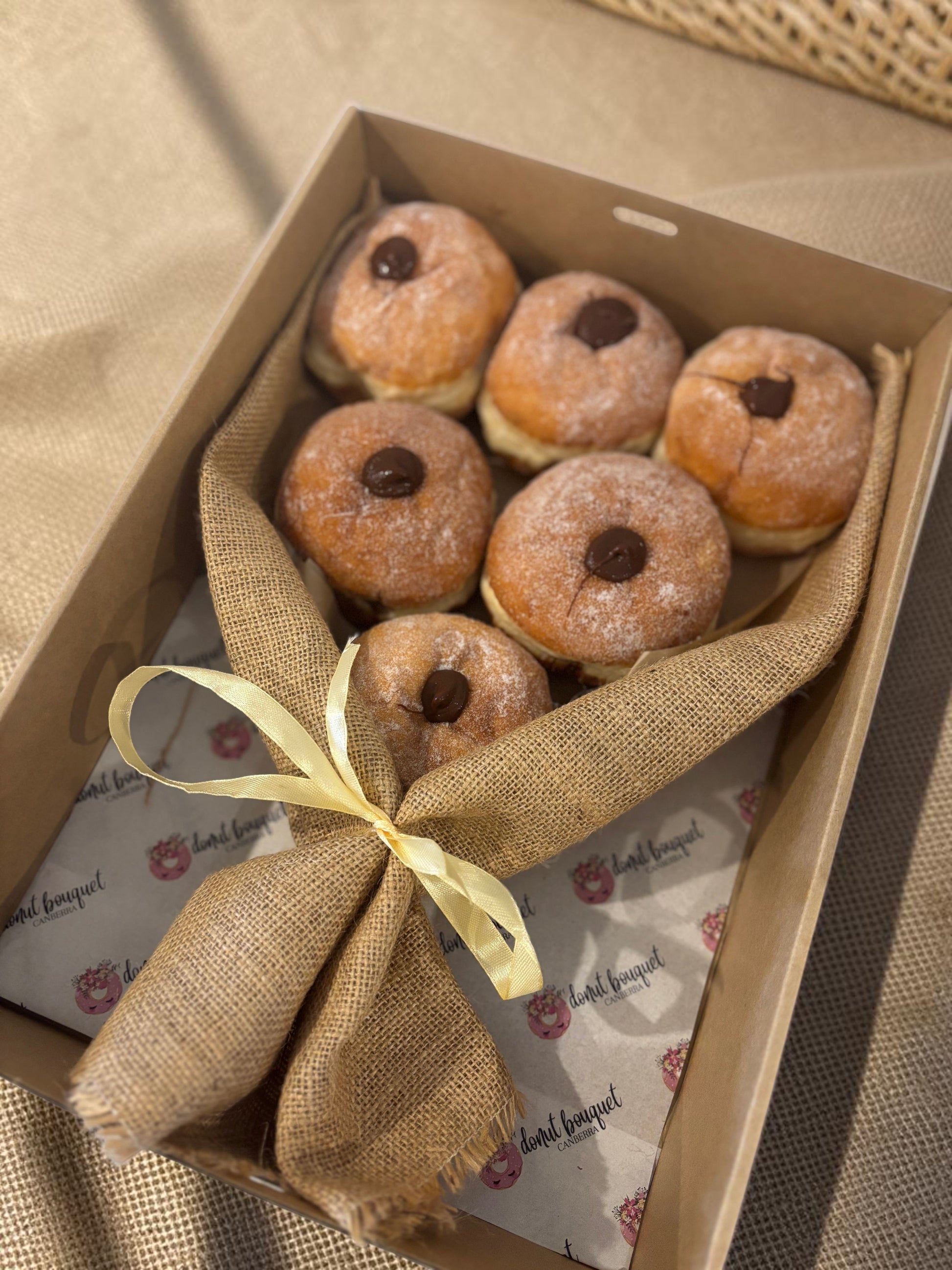 Donut Bouquet Canberra premium 6 pack Nutella donut bouquet wrapped in rustic hessian with a ribbon in a box