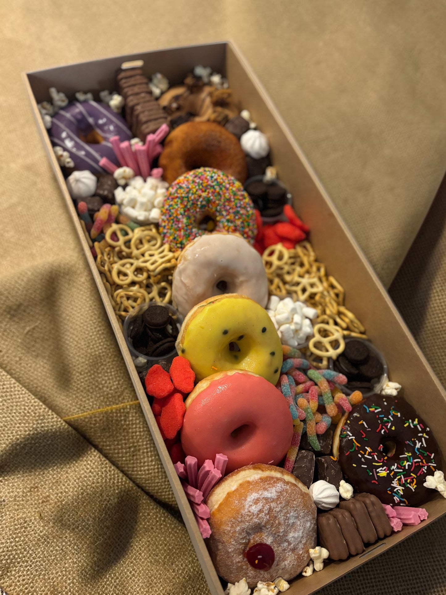 Donut Bouquet Canberra sweets grazing box filled with assorted donuts, pretzels, lollies, and chocolate treats.