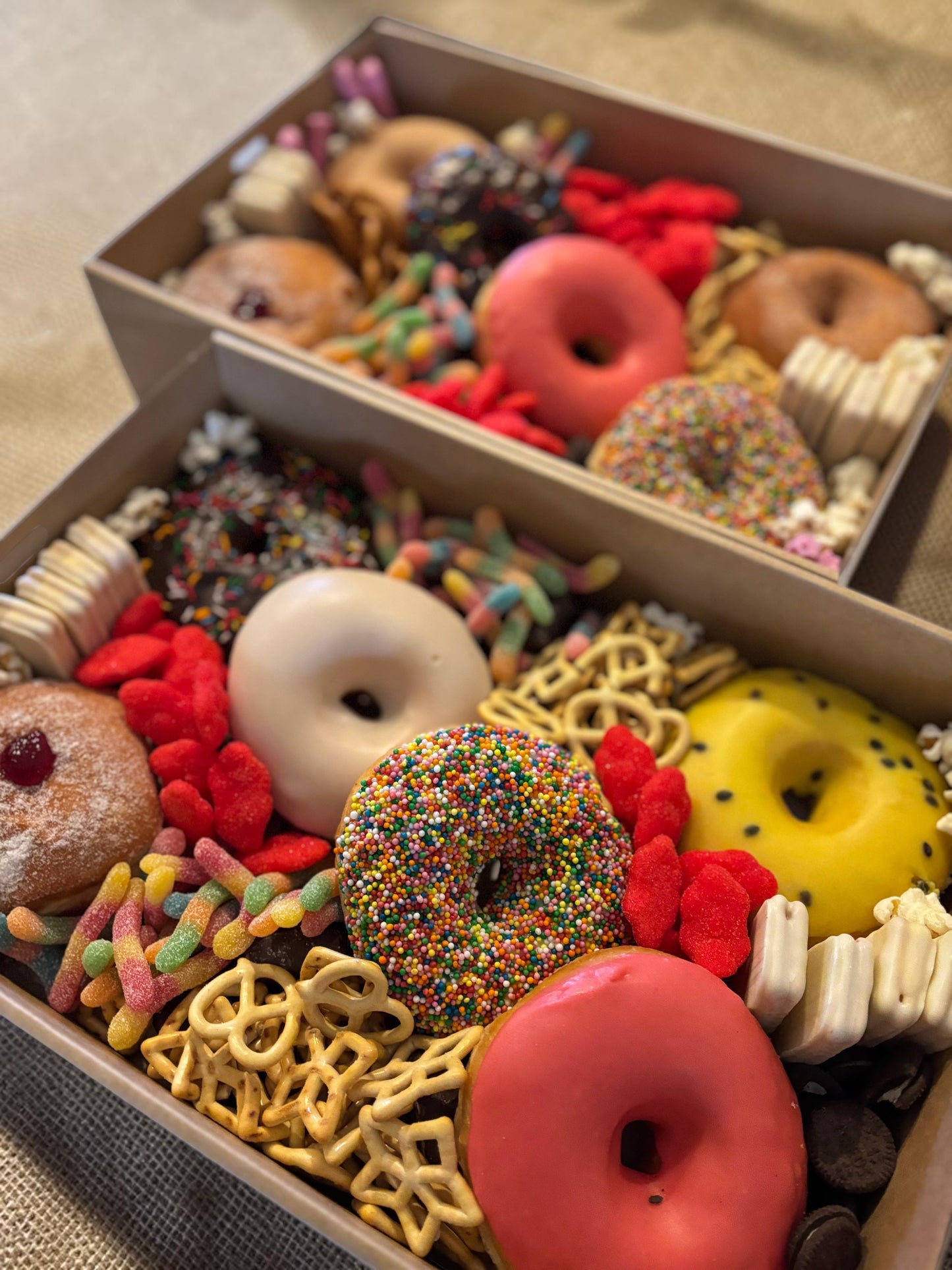 Donut Bouquet Canberra sweets grazing box filled with assorted donuts, pretzels, lollies, and chocolate treats.