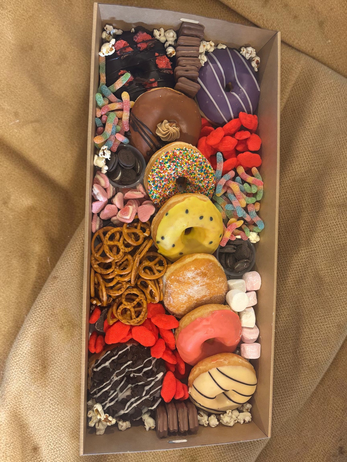 Donut Bouquet Canberra sweets grazing box filled with assorted donuts, pretzels, lollies, Oreos, and Tim Tams.
