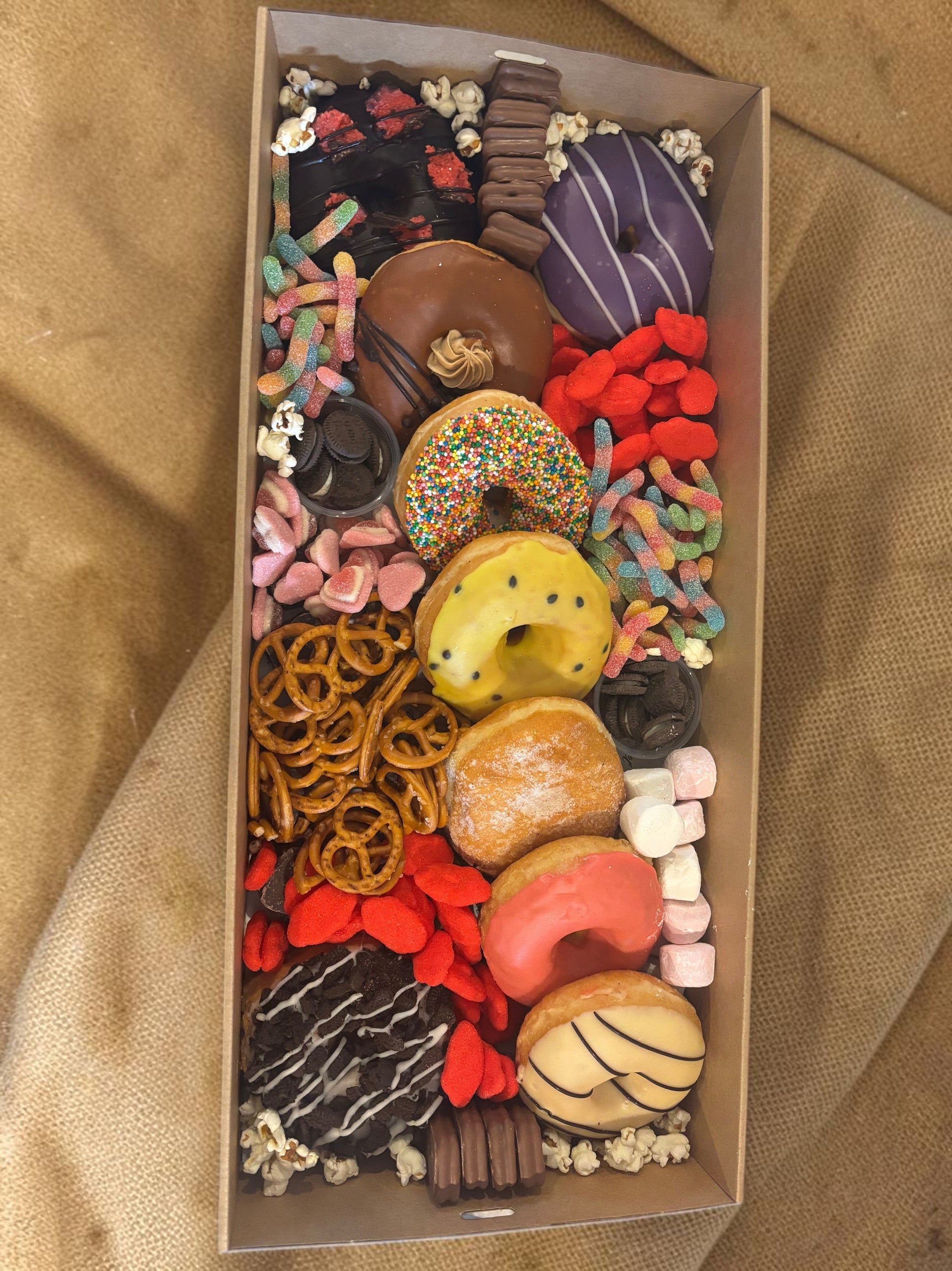 Donut Bouquet Canberra sweets grazing box filled with assorted donuts, pretzels, lollies, Oreos, and Tim Tams.