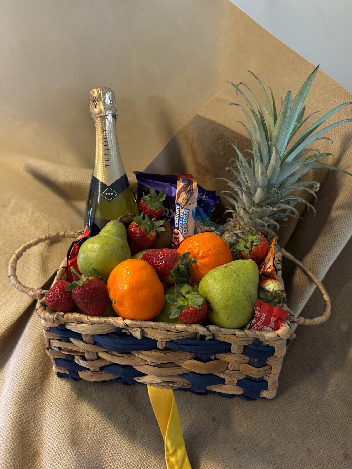 Donut Bouquet Canberra gift hamper featuring sparkling wine, fresh strawberries, pears, oranges, and chocolates.